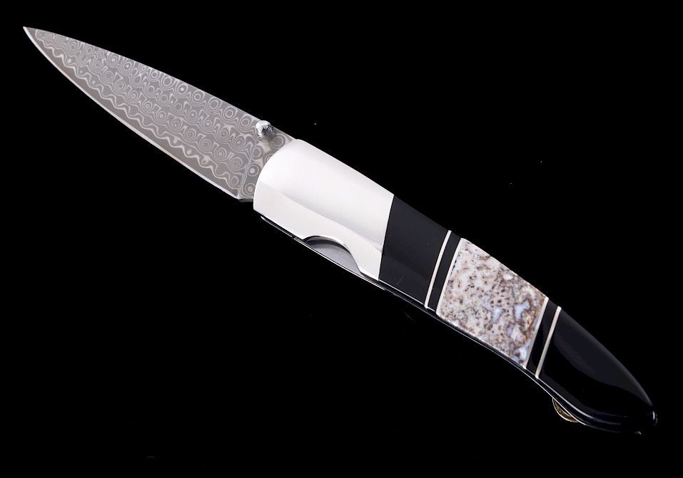 Appraisal: Brontosaurus Fossil Raindrop Damascus Knife This is an original pre-historic