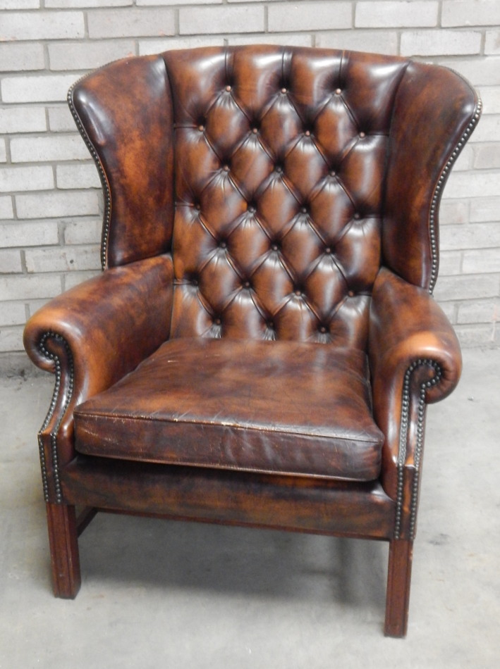 Appraisal: A thC brown club wing armchair in brown button back