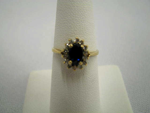 Appraisal: Sapphire Diamond Ring oval deep blue gem surrounded by diamonds