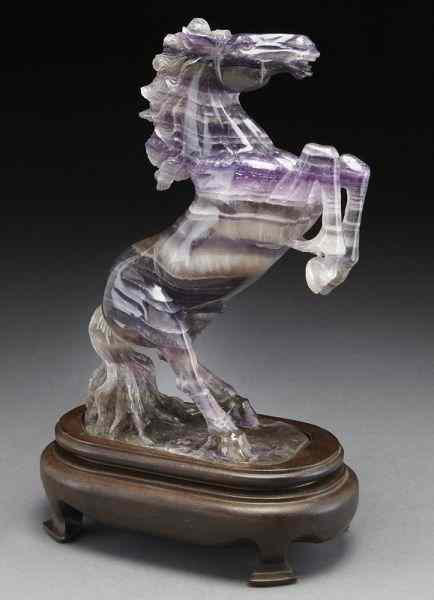 Appraisal: Carved amethyst horse raised on a wood base Without stand