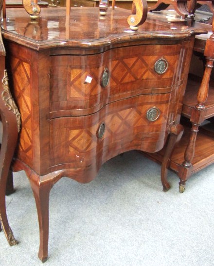 Appraisal: A Continental mahogany and marquetry serpentine small commode with two