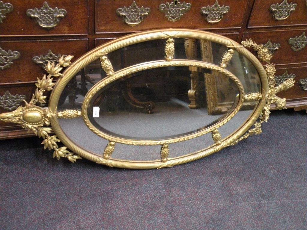 Appraisal: A thC giltwood oval wall mirror