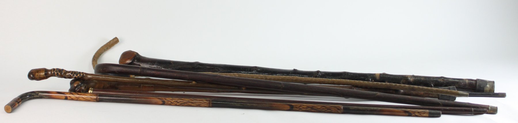 Appraisal: Two Irish shillelaghs and six walking canes including a gold