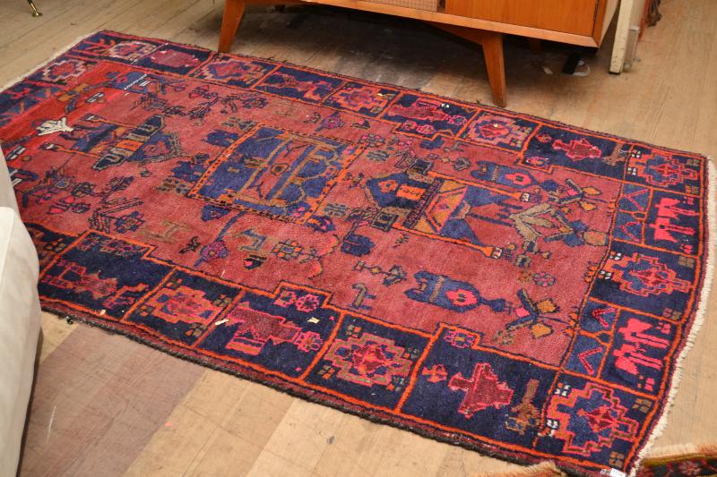 Appraisal: A HAND STITCHED TRIBAL RUG IN PINK NAVY AND BURGUNDY