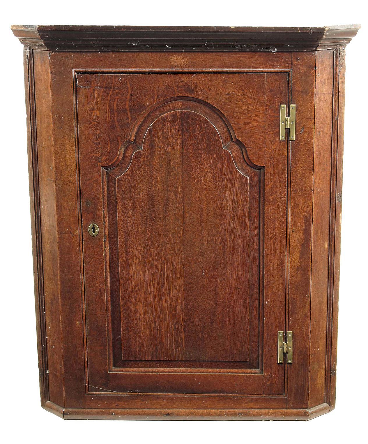 Appraisal: A George III oak hanging corner cupboard