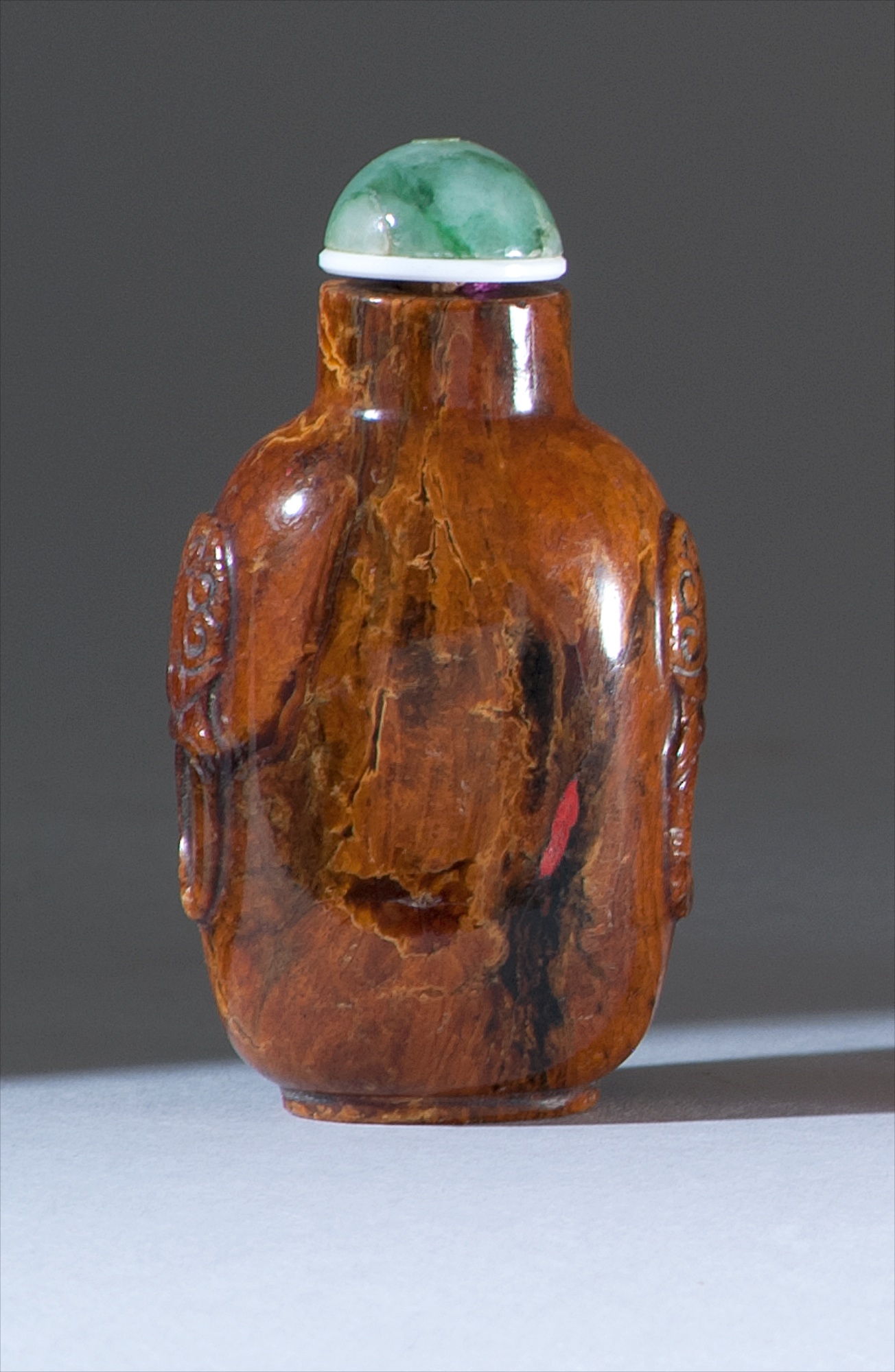 Appraisal: AMBER SNUFF BOTTLE th CenturyIn spade shape with mask and