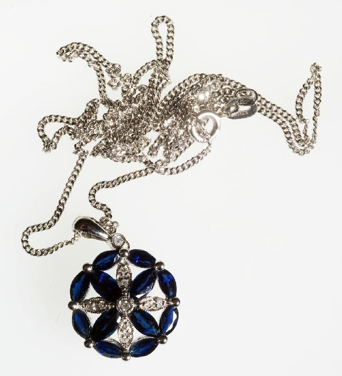 Appraisal: SAPPHIRE AND DIAMOND PENDANT the central flower motif with millegrain