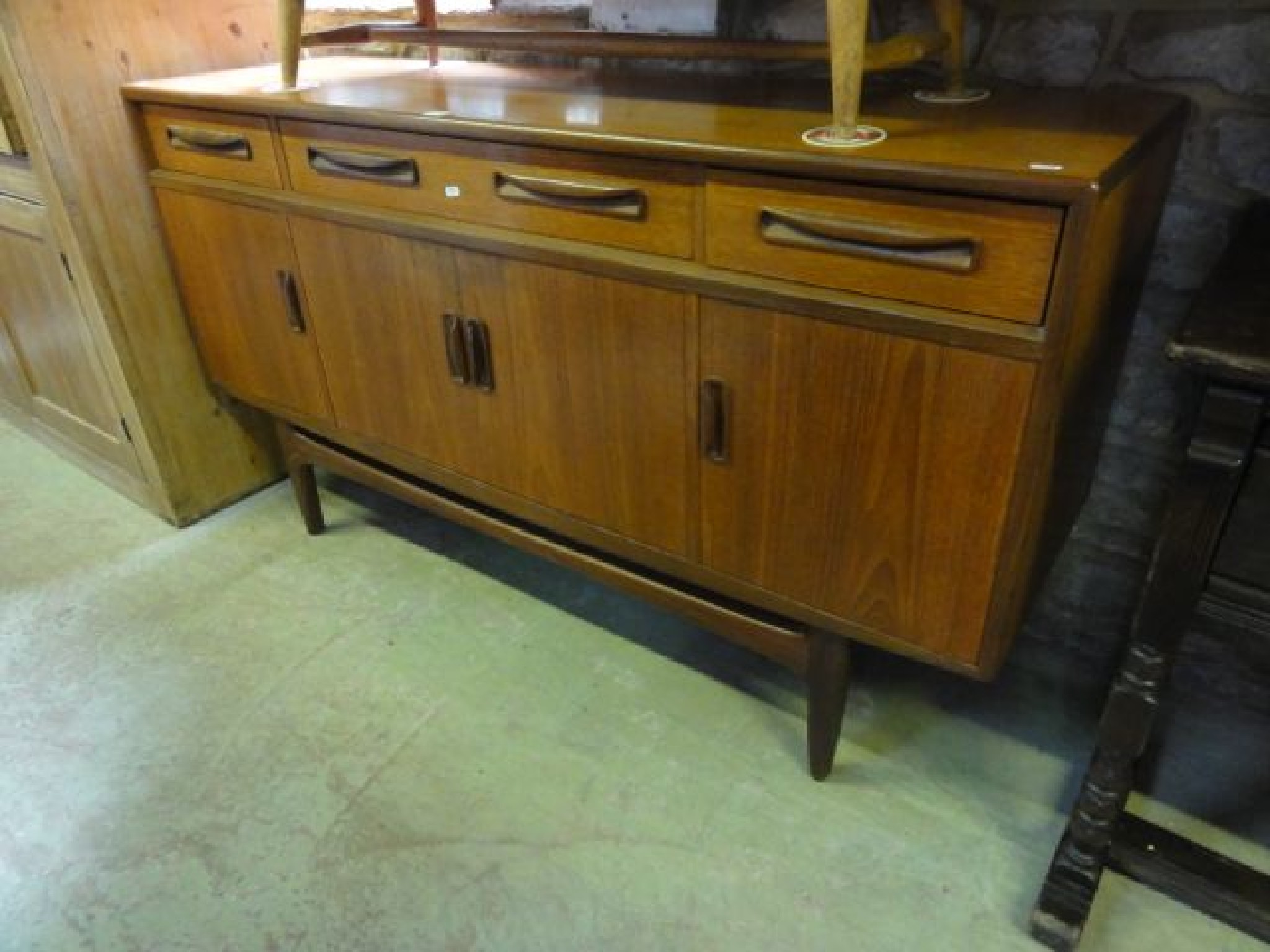 Appraisal: A G plan teak Fresco sideboard enclosed by four doors