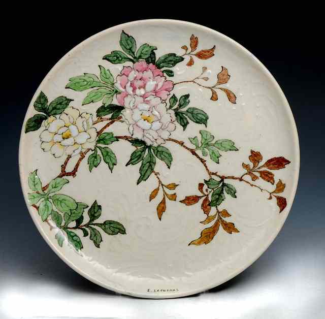 Appraisal: An Edmond Lachenal pottery plate decorated with flowering branches signed