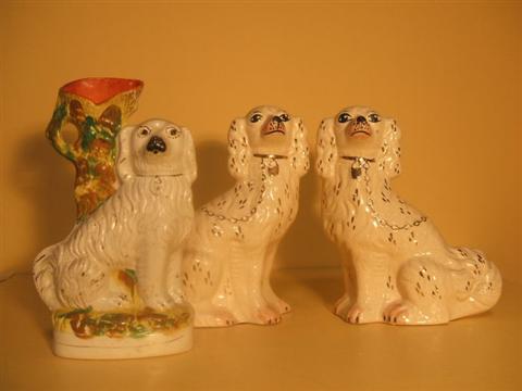 Appraisal: TWO STAFFORDSHIRE SPANIELS AND A VASE The first modeled seated