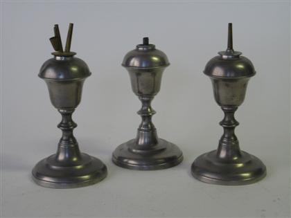 Appraisal: Three pewter urn-form lamps Including a pair each with double-reel