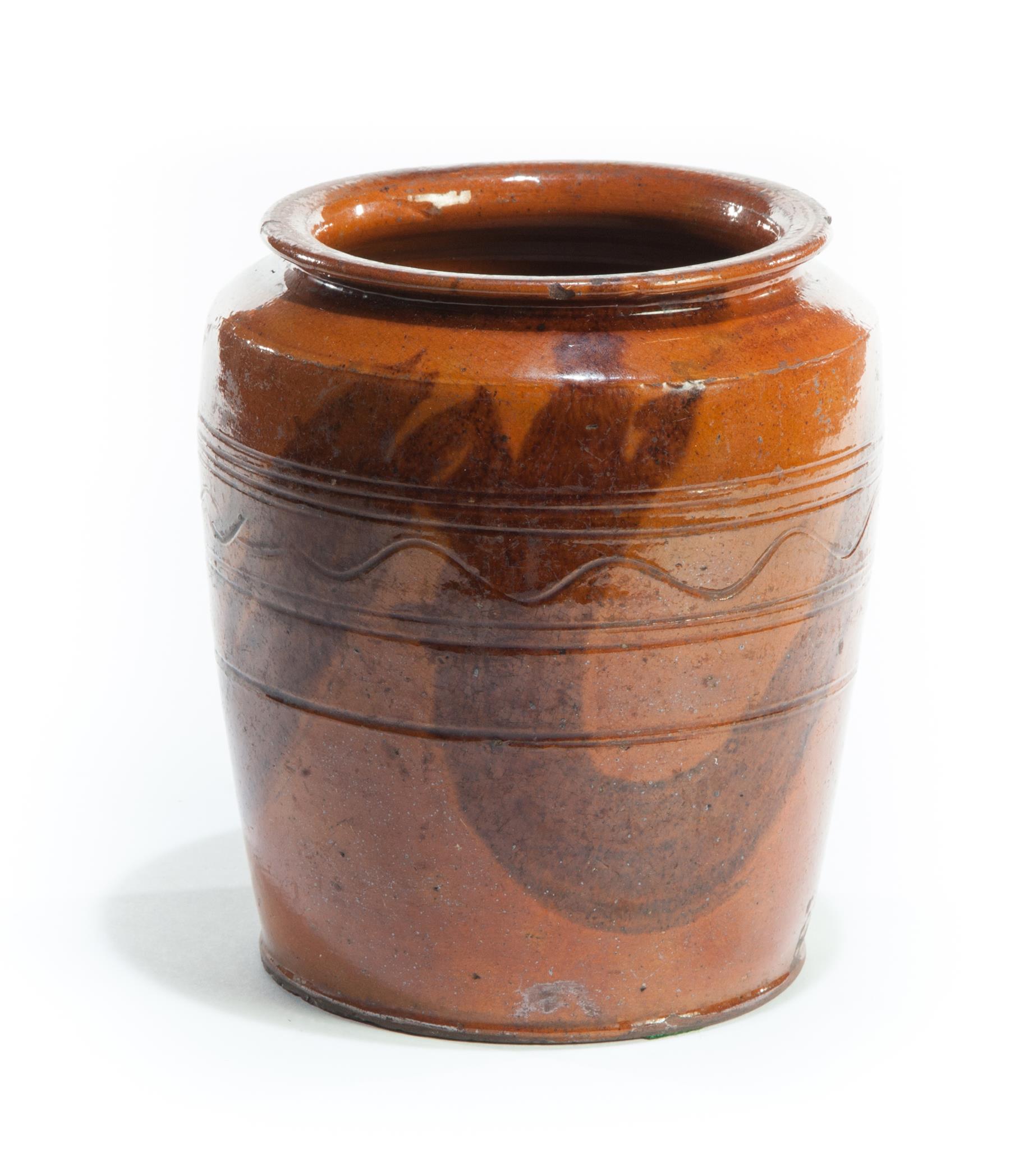 Appraisal: PENNSYLVANIA REDWARE STORAGE JAR Nineteenth century Squat with incised wavy