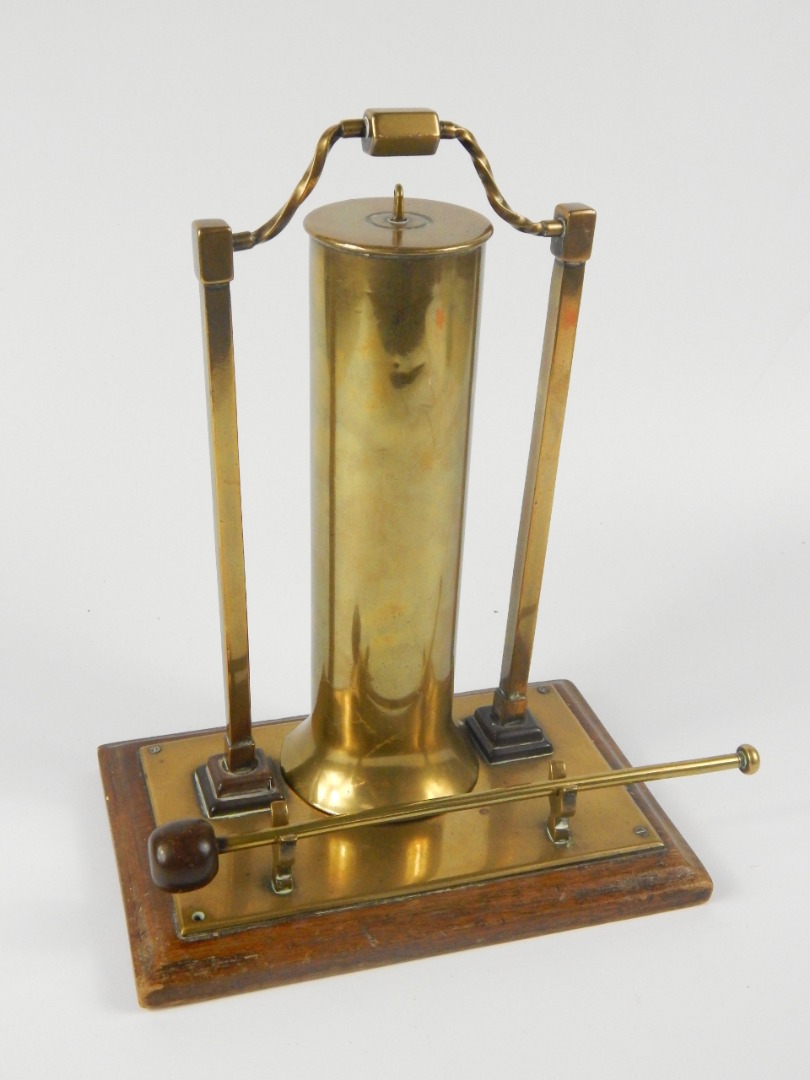 Appraisal: A brass shell case table gong raised on a rectangular