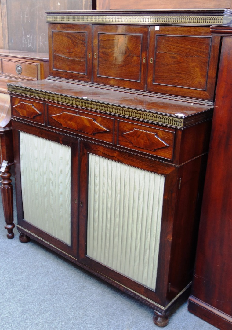 Appraisal: A Regency brass inlaid rosewood side cabinet with triple cupboard