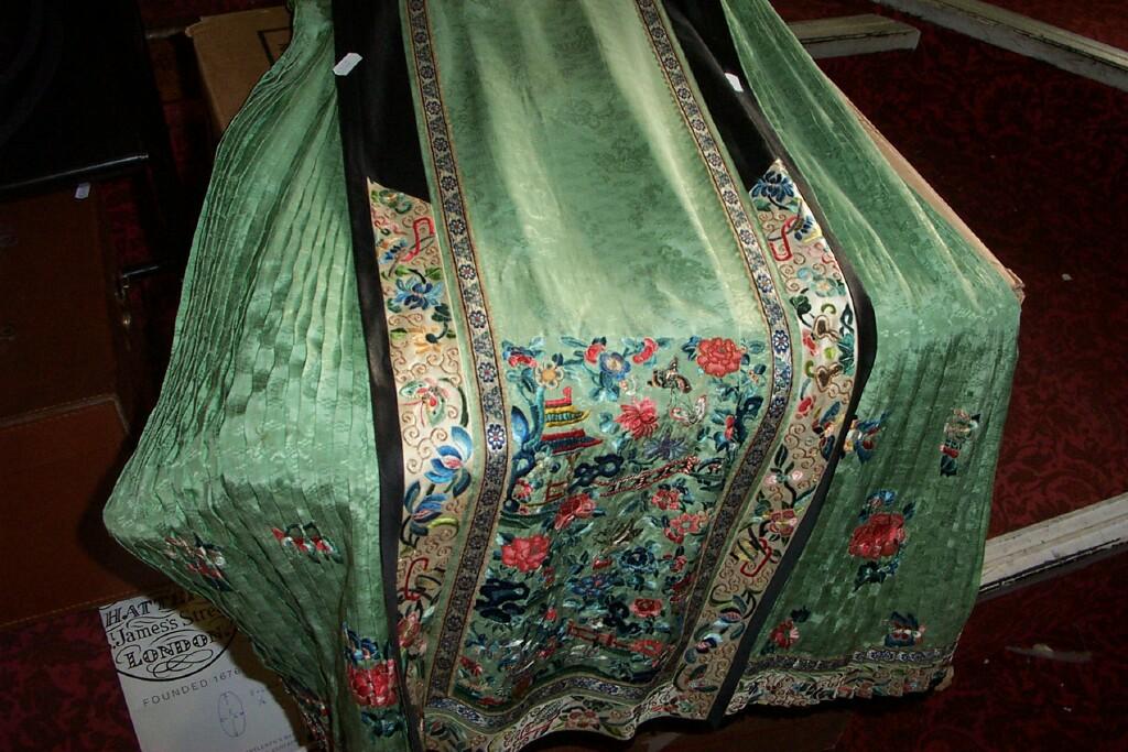 Appraisal: An early th century Chinese green silk skirt with polychrome