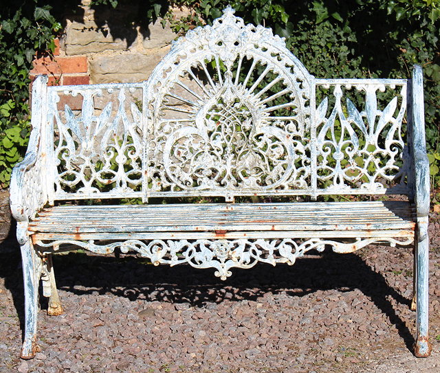 Appraisal: A CAST IRON GARDEN BENCH the elaborately cast back with