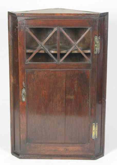 Appraisal: An early th Century oak corner cupboard with glazed bar