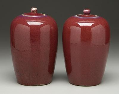 Appraisal: Near pair Chinese sang-de-boeuf lidded jars conical with streaky red