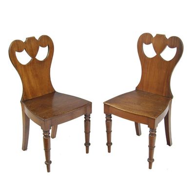 Appraisal: A pair of Victorian mahogany hall chairs the waisted and