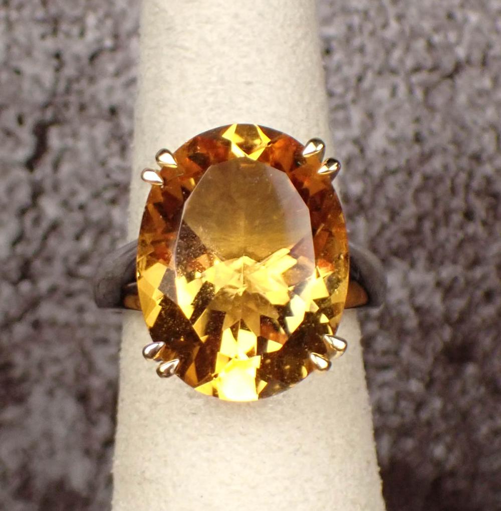 Appraisal: CITRINE AND FOURTEEN KARAT TWO-TONE GOLD RING The white and