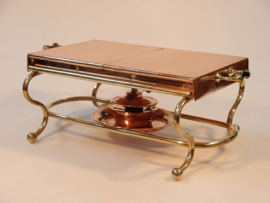 Appraisal: A Benson style planished copper warming tray fitted with brass