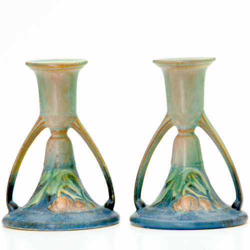 Appraisal: ROSEVILLE Pair of green Baneda candlesticks Small touch-up to one