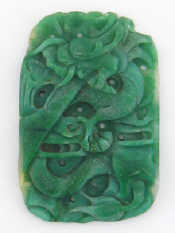 Appraisal: A carved jade amulet the oblong body carved in relief