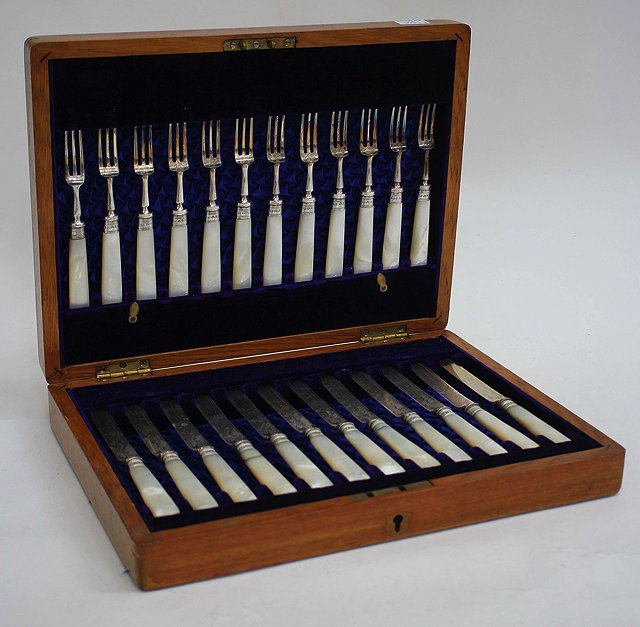 Appraisal: A SET OF TWELVE SILVER PLATED FRUIT KNIVES AND FORKS