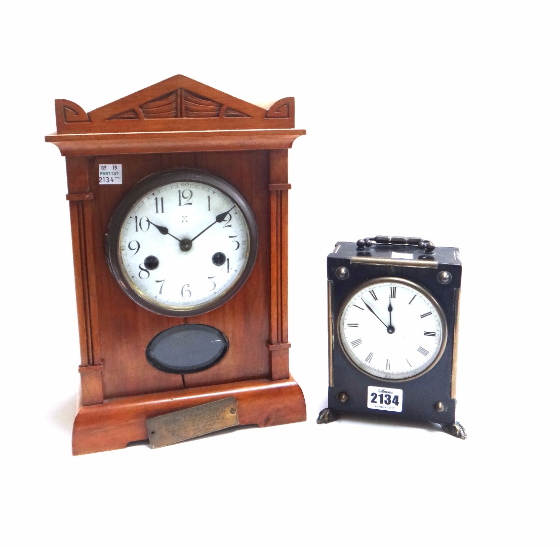 Appraisal: A Victorian ebonised mantel clock with white enamel dial on