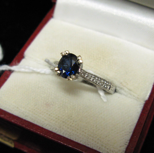 Appraisal: DIAMOND BLUE SAPPHIRE AND FOURTEEN KARAT WHITE GOLD RING The