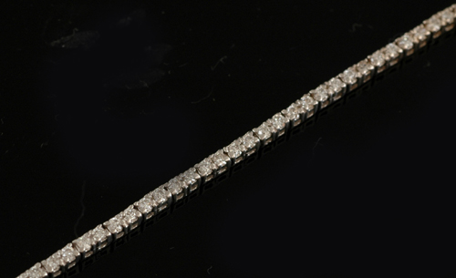 Appraisal: A diamond line bracelet Comprising a single line of round