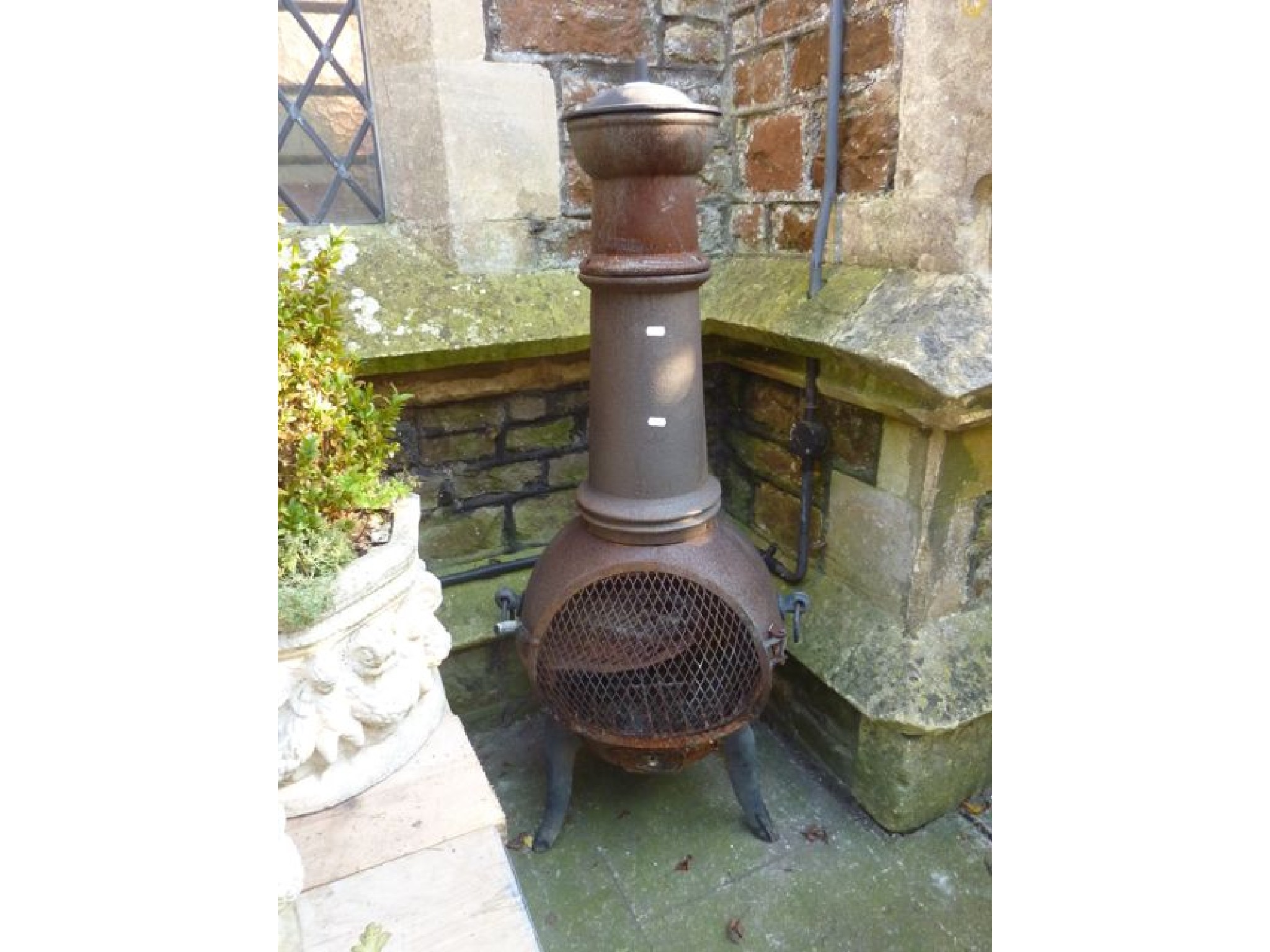 Appraisal: A weathered contemporary cast iron chimnea with pot belly and