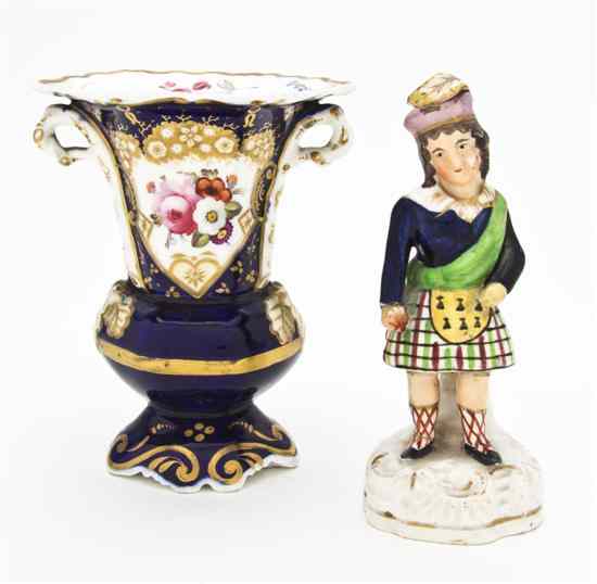 Appraisal: A Staffordshire Figure depicting a Scotsman together with a Rockingham