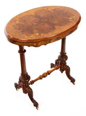 Appraisal: A Victorian walnut table the oval inlaid top on twin-turned