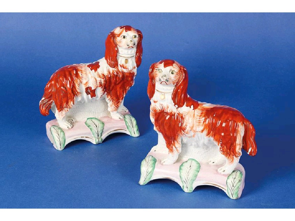 Appraisal: A PAIR OF STAFFORDSHIRE FLAT BACK SPANIELS decorated in rust