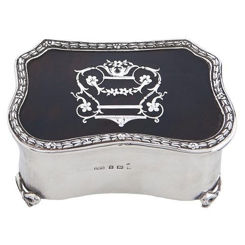 Appraisal: An Edwardian commode shaped silver inlaid tortoiseshell inset trinket box