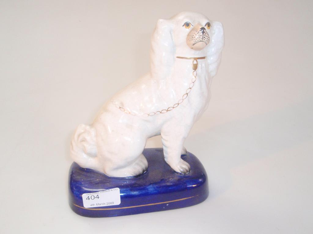 Appraisal: A thC Staffordshire pottery seated spaniel with separate front legs