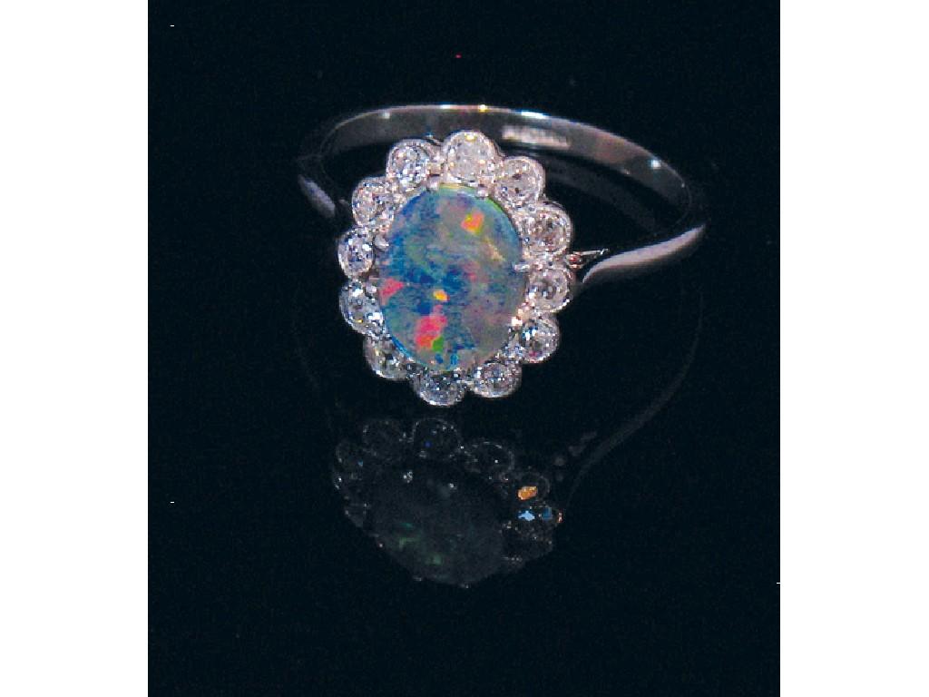 Appraisal: A BLACK OPAL AND DIAMOND DRESS RING the central oval