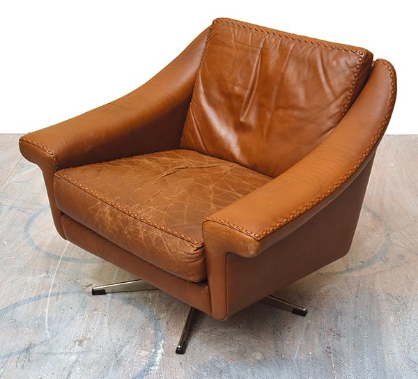 Appraisal: DANISH LEATHER LOUNGE CHAIR WITH EXPOSED STITCHING ON SWIVEL BASE