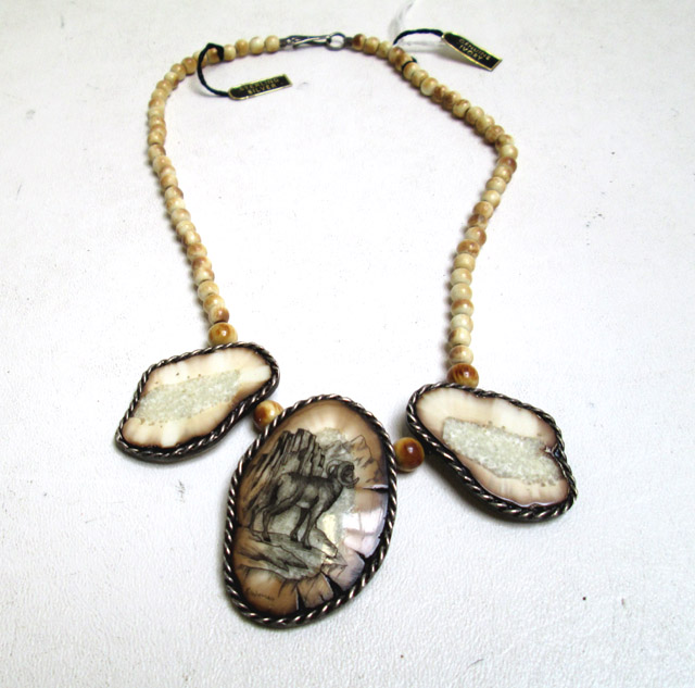 Appraisal: PETRIFIED WALRUS TUSK IVORY SCRIMSHAW NECKLACE featuring a scrimshaw portrait