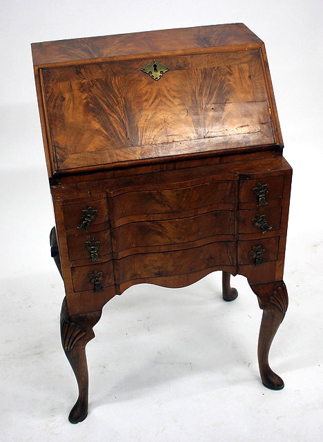 Appraisal: A SMALL WALNUT VANEERED BUREAU with fall front and serpentine