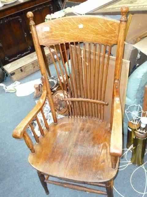 Appraisal: AN AMERICAN OAK ARMCHAIR with waisted stick back carved seat