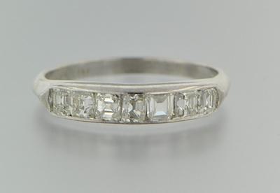 Appraisal: A Platinum and Diamond Band Platinum band features a row