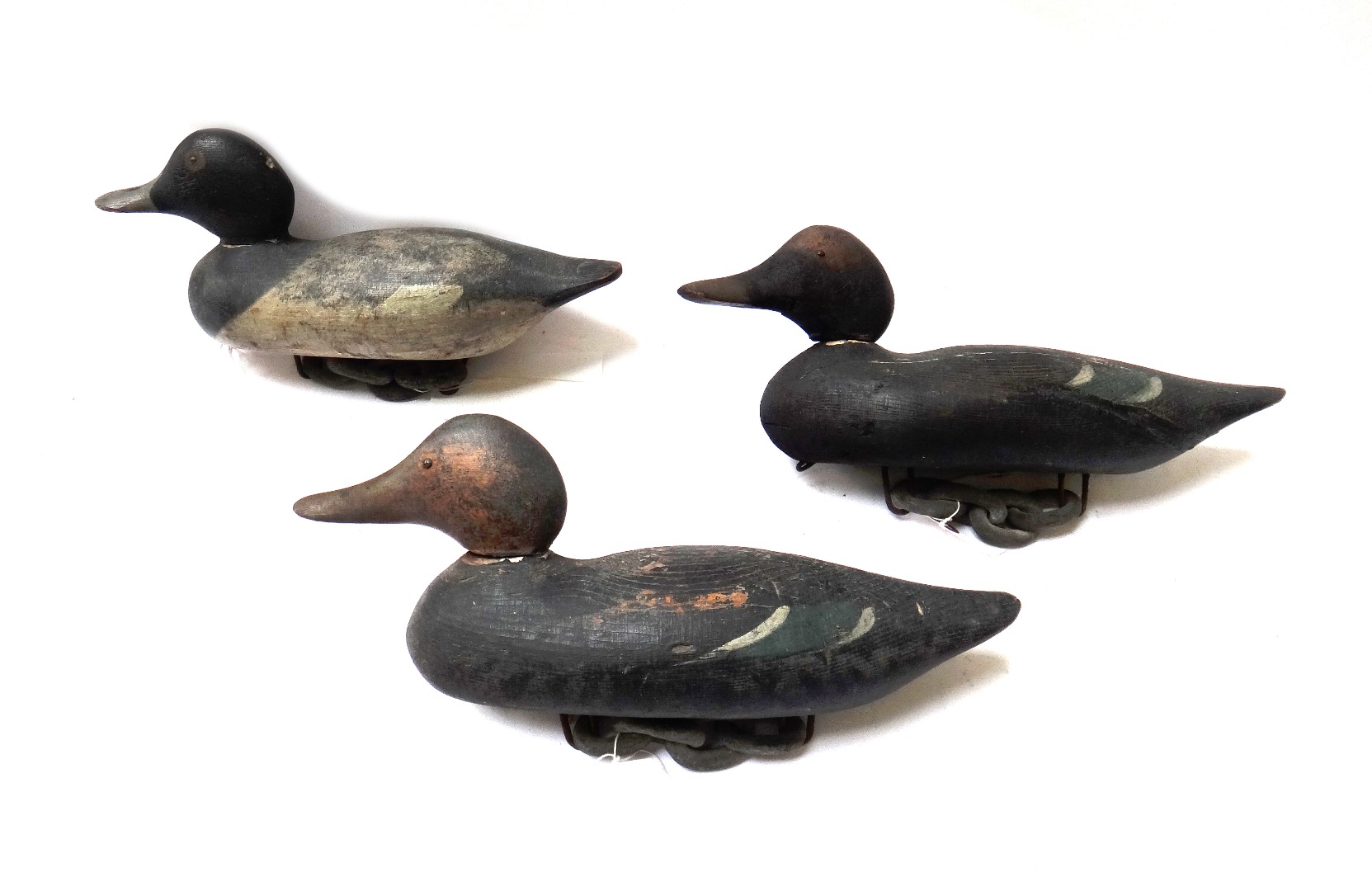 Appraisal: Three painted softwood decoy ducks early th century with chain