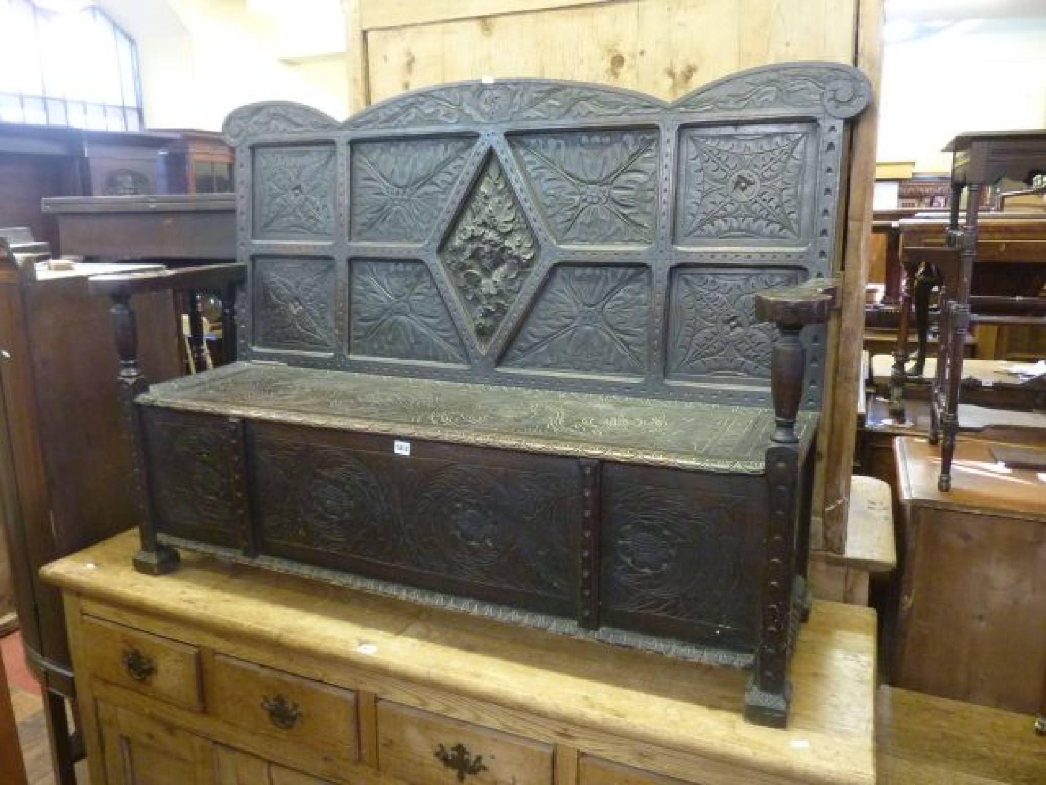 Appraisal: A th century carved oak box settle with rising lid