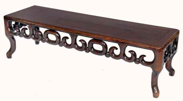 Appraisal: A CHINESE HARDWOOD LOW TABLE with scroll frieze on shaped