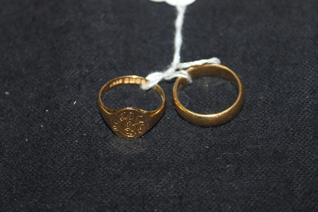 Appraisal: A GOLD WEDDING BAND and a gold signet ring monogrammed