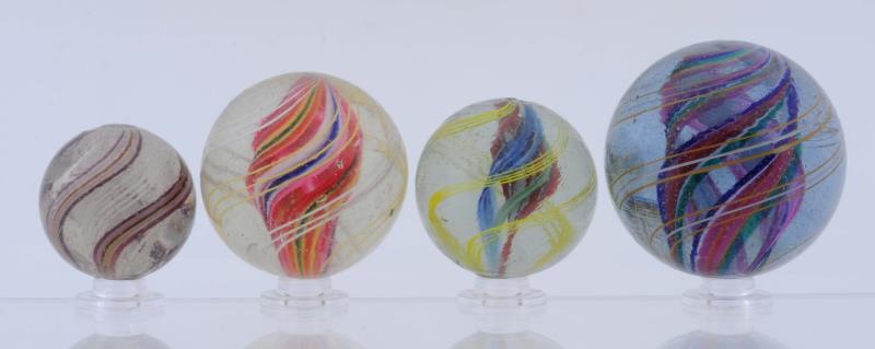 Appraisal: Lot Of Swirl Marbles Lot includes three multicolor divided core