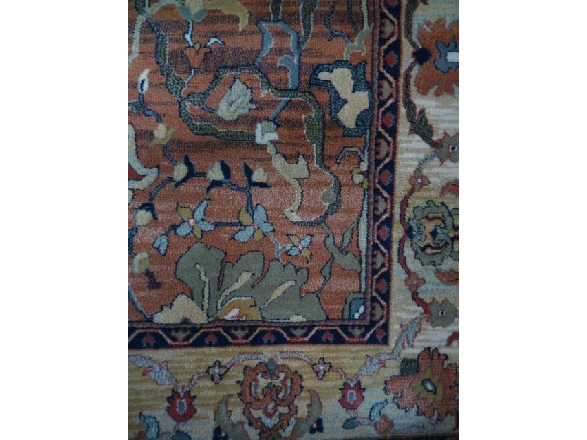 Appraisal: A contemporary Persian style rug with amber coloured ground with