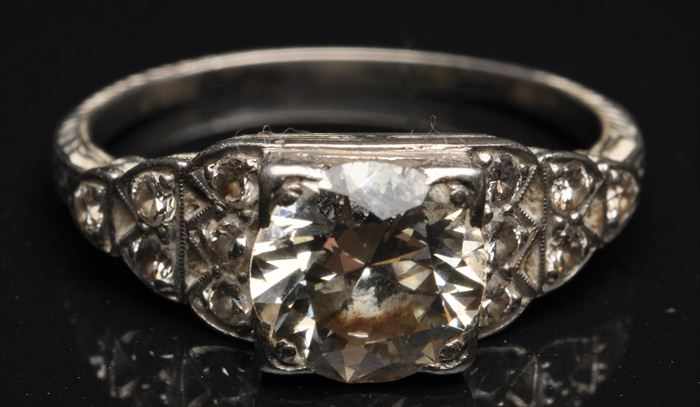 Appraisal: DIAMOND RING Central stone with five small stones on each